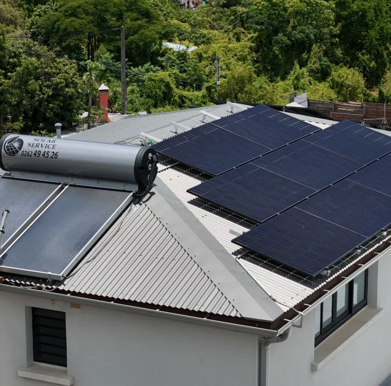 Exemple de différence sur un toit à La Réunion entre un panneau solaire pour l'eau chaude et des panneaux photovoltaïques