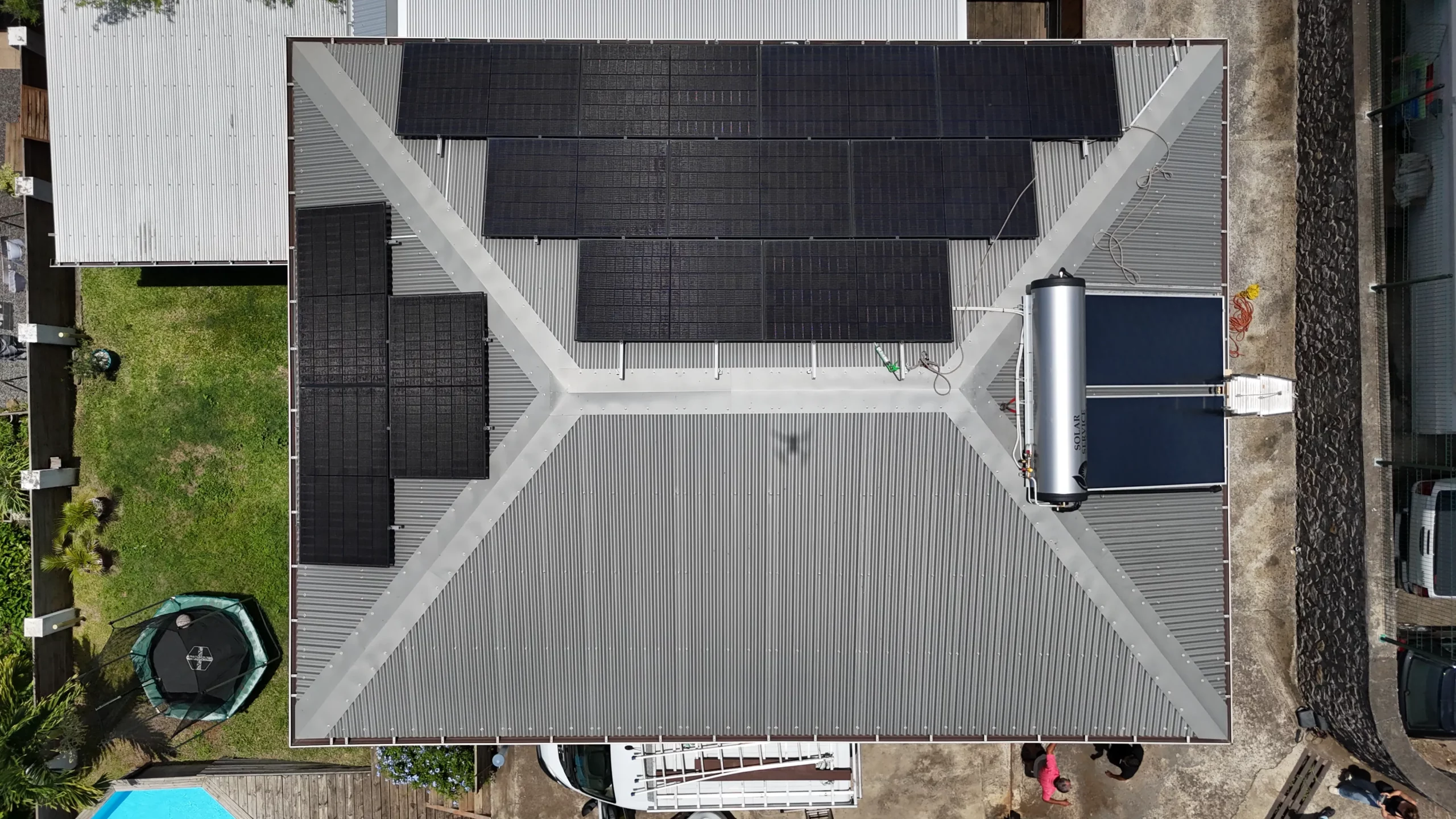 Distinction entre le capteur d'un chauffe-eau solaire et les cellules d'un panneau photovoltaïque sur une villa au 974